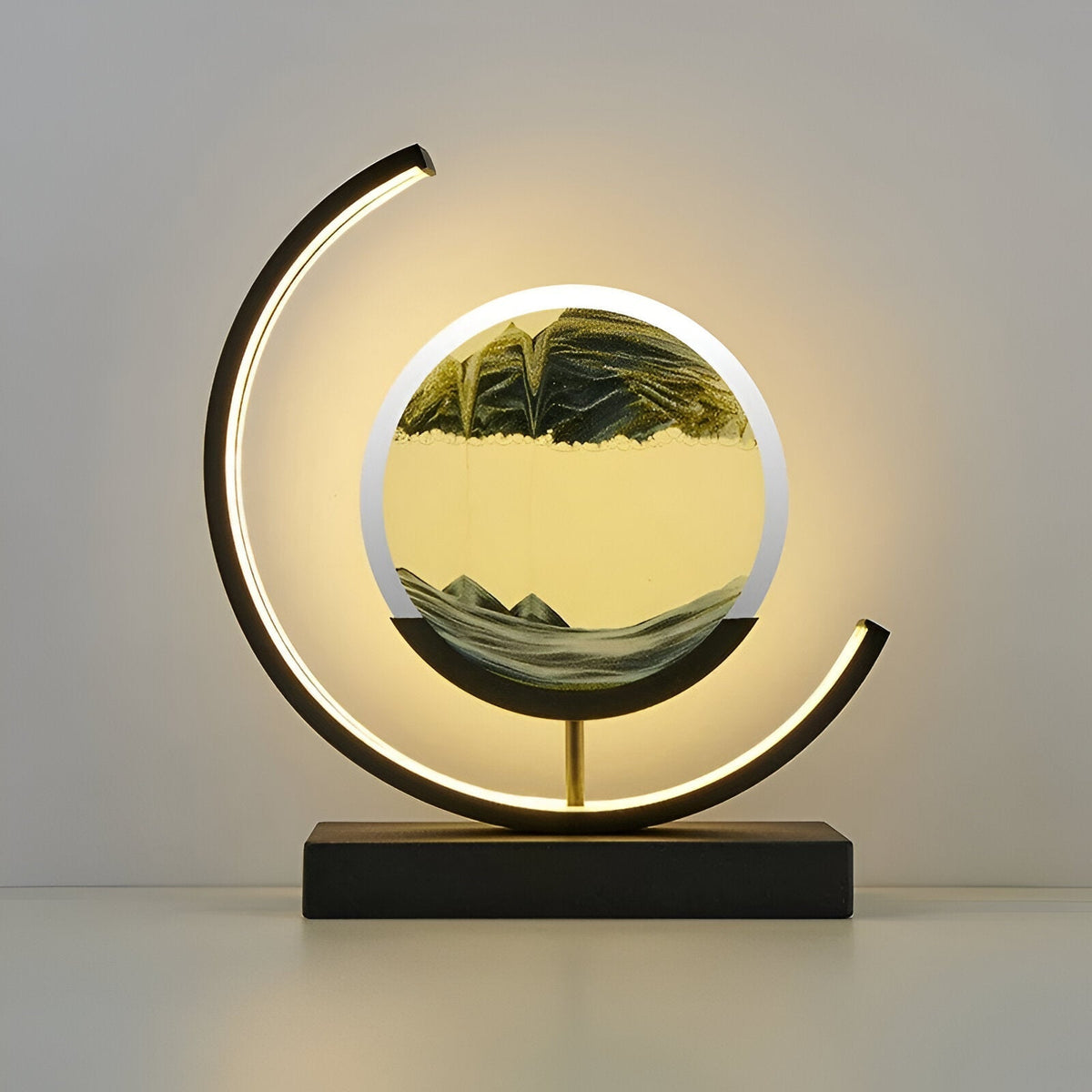 Illuminated youj black LED sand art light highlighting the detailed green falling sand