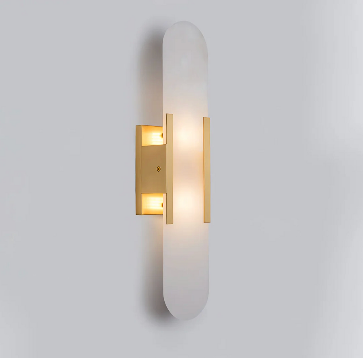 Front view of the illuminated gold marble capsule yuhy wall sconce