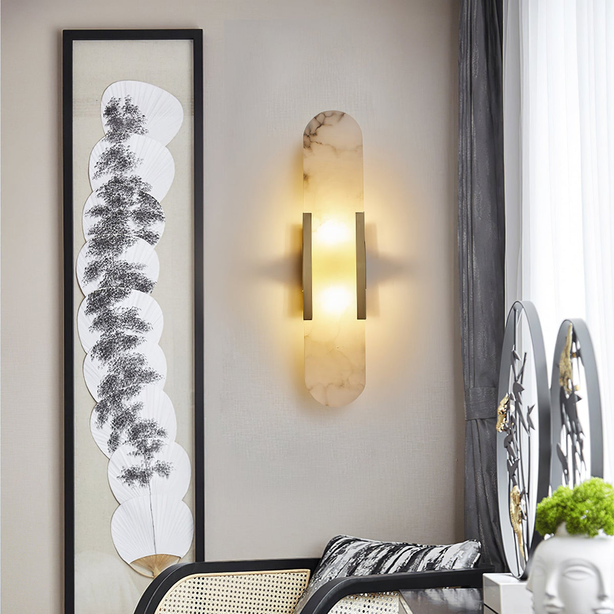 Gold natural stone yuhy wall light highlighting contemporary artwork in a stylish living space