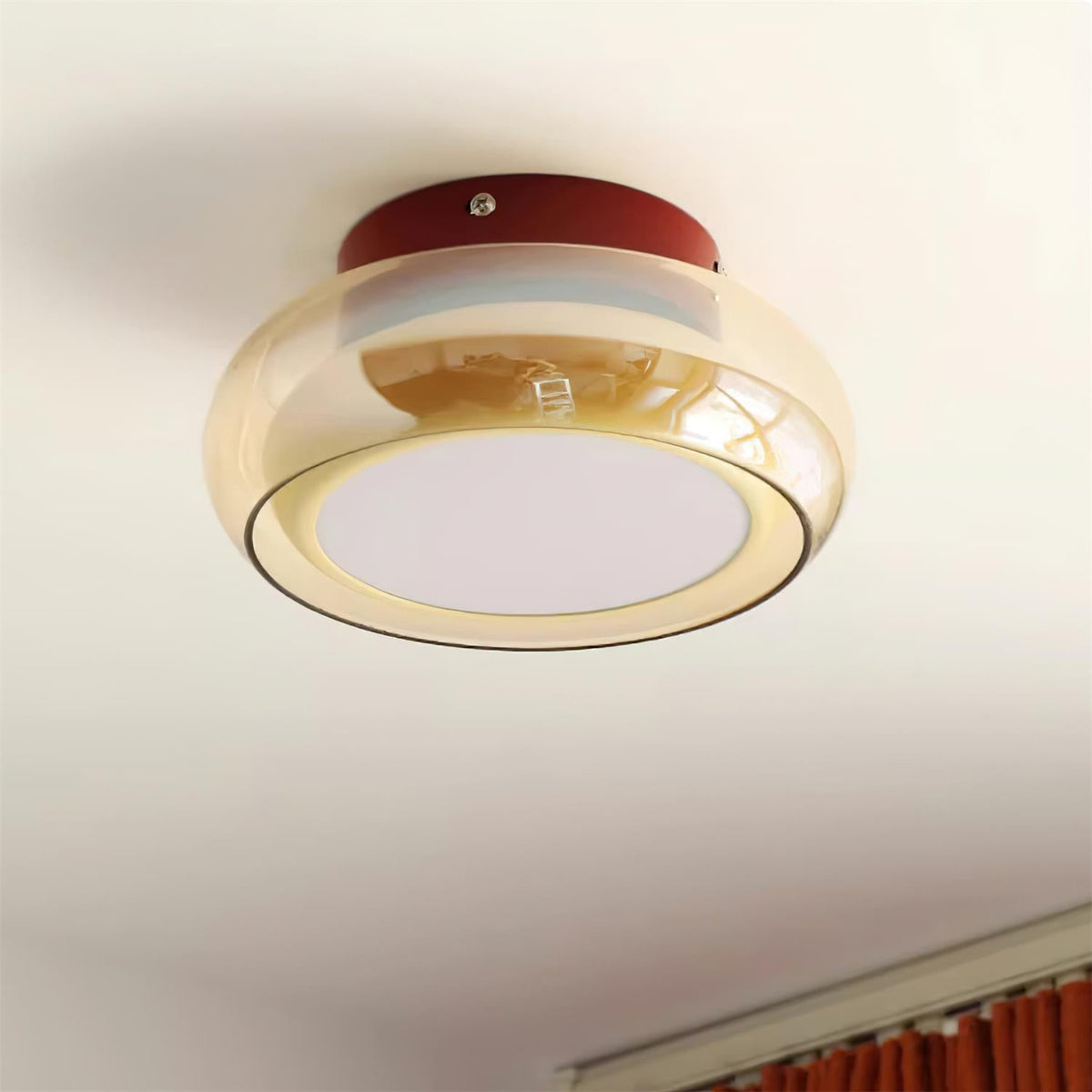 Angled view of the red and amber glass zuba ceiling fixture installed on a white ceiling