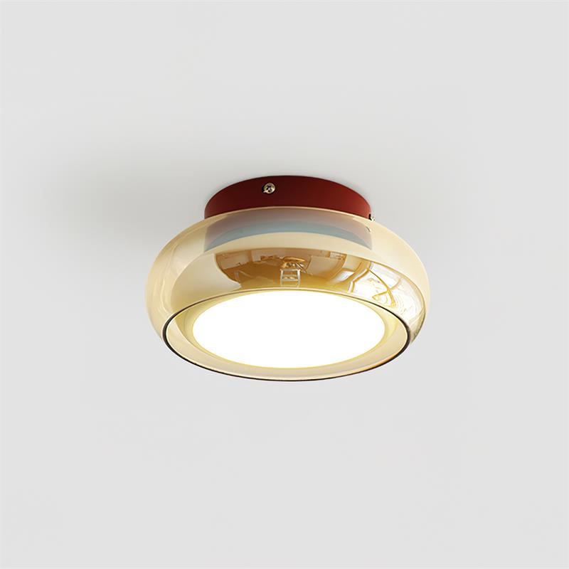 Isolated view of the mid-century zuba ceiling lamp with a red base and amber glass shade